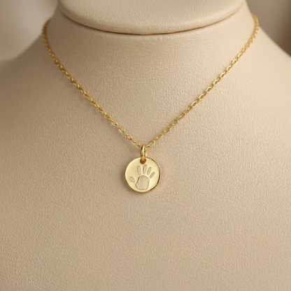 Gold chain necklace with one round handprint pendant on a clasp bail