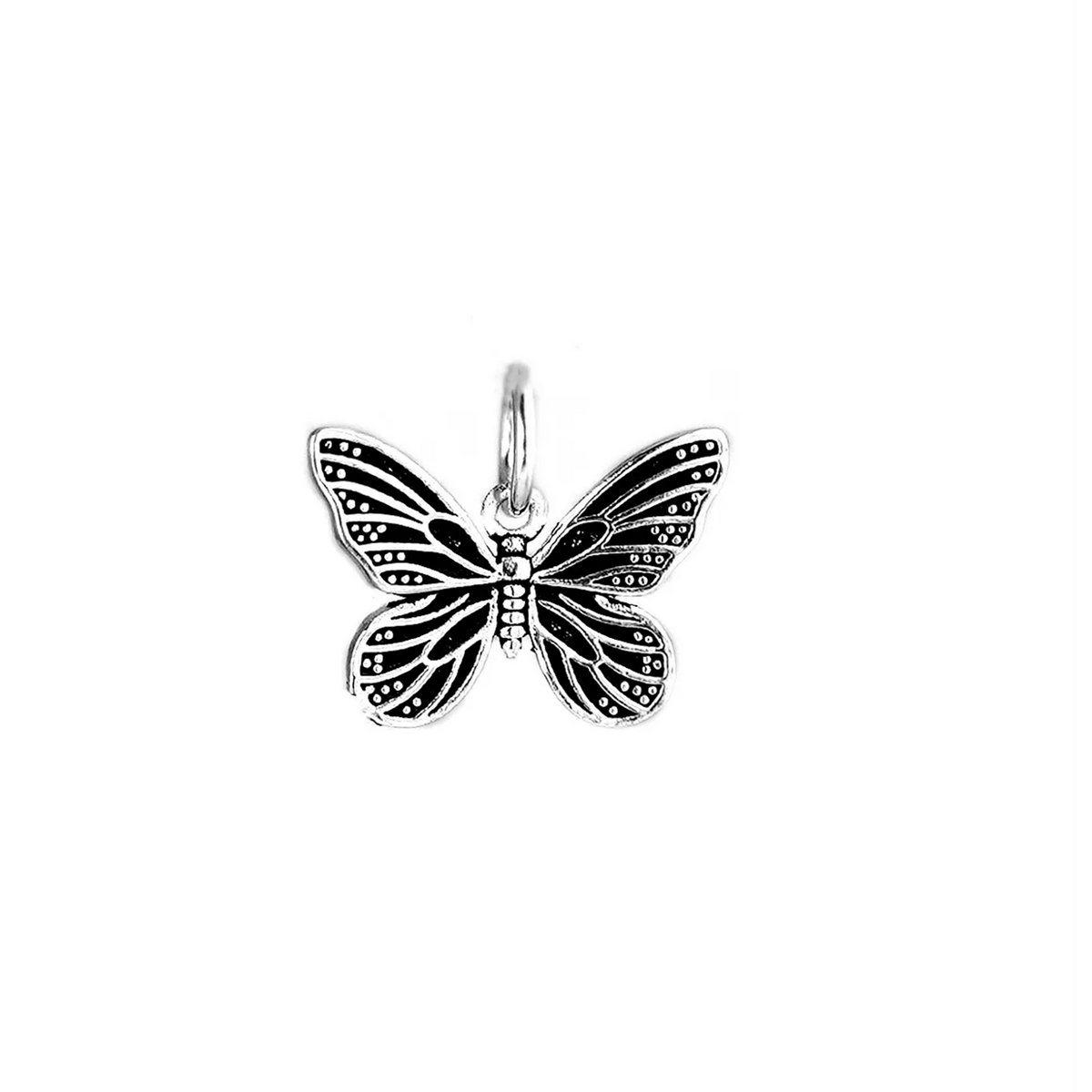 Silver butterfly charm pendant with ornate filigree, top view on white background
