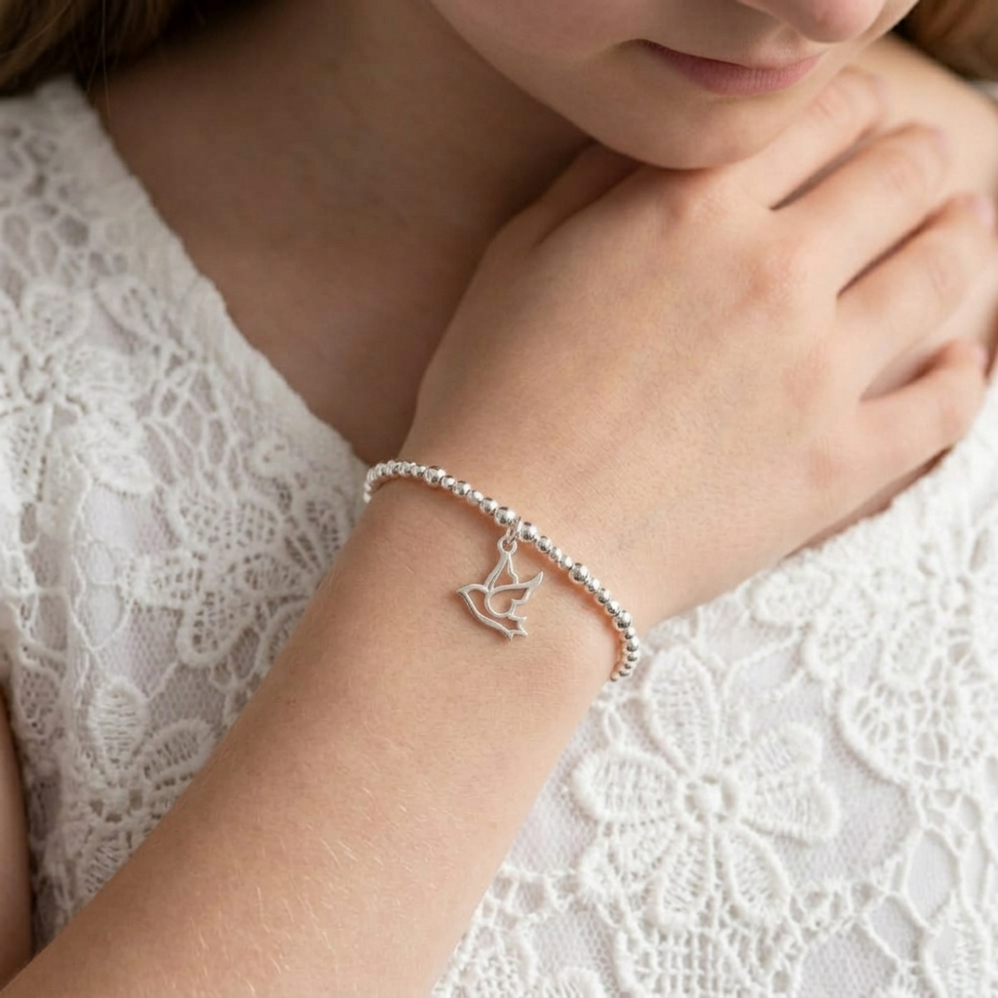 Silver dove peace charm bracelet with small heart-shaped cutout