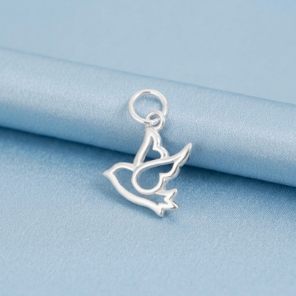 Silver dove peace charm on blue fabric, round ring top and cutout details