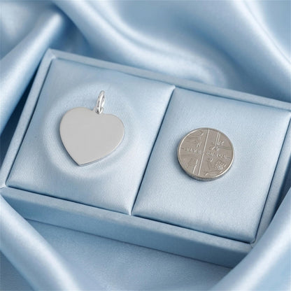 Heart pendant with polished silver loop, smooth white heart face in display box