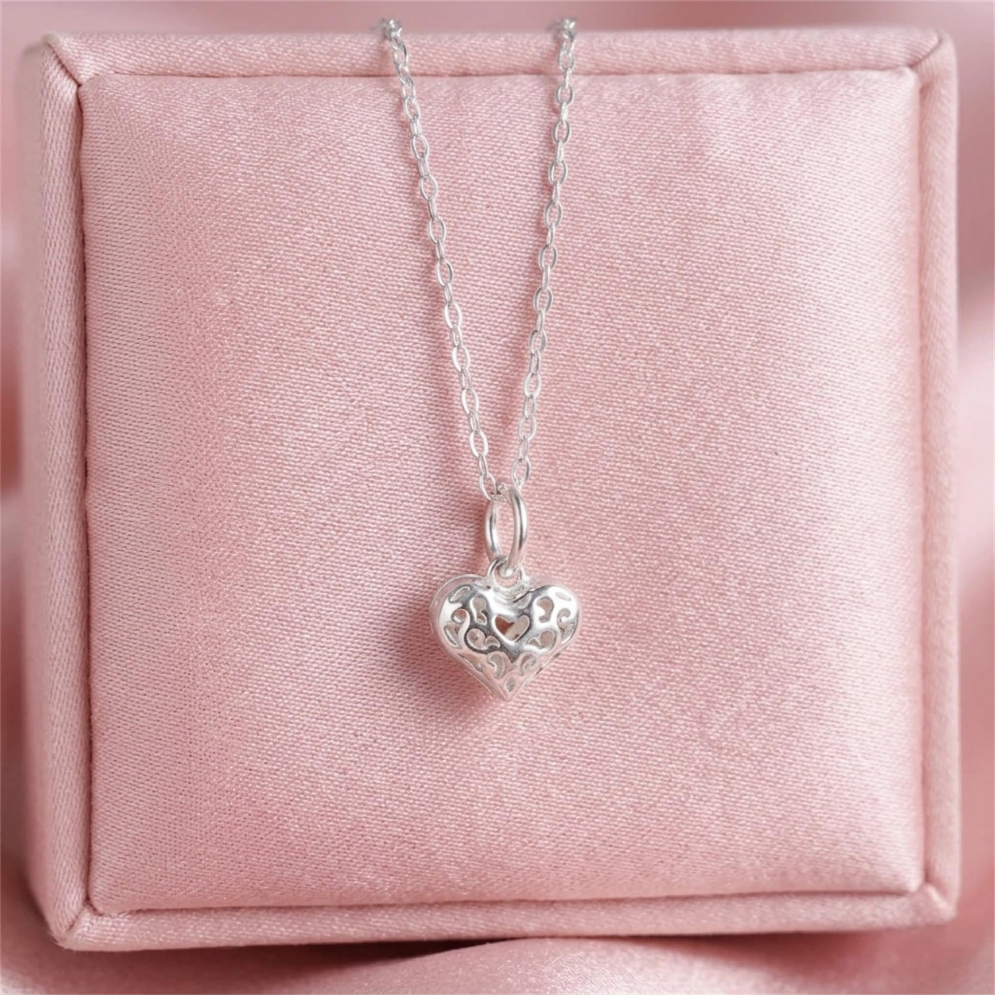 Heart pendant necklace display with filigree heart charm and loop