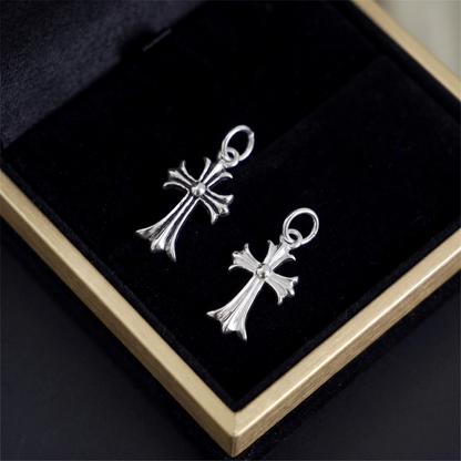 Two-tone fleur-de-lis cross charm hook earrings, silver cross design close-up