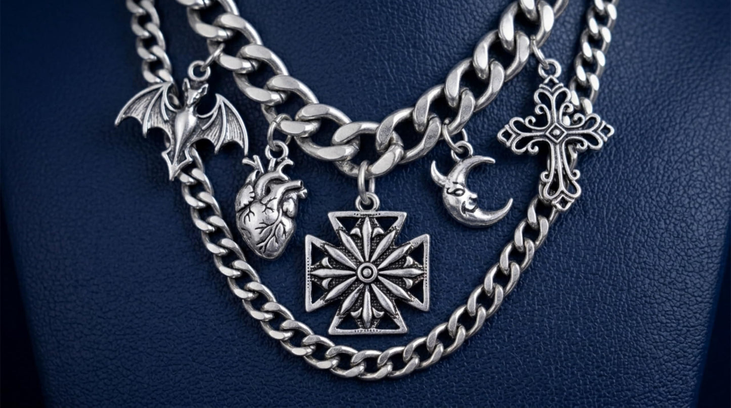 Oxidised Maltese star pendant shown among layered silver chains and charms