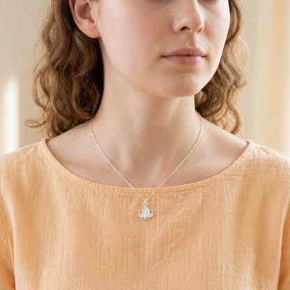 Lotus flower charm necklace with silver chain and lotus pendant at the collar