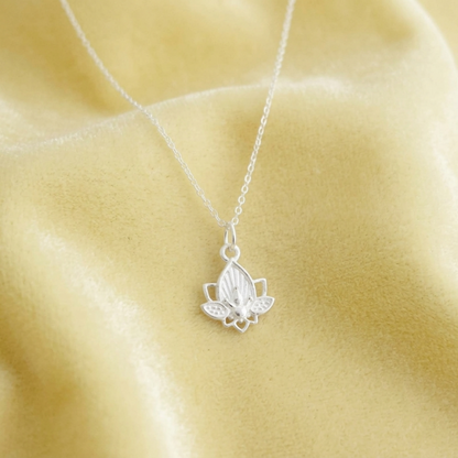 Lotus flower charm necklace with silver chain and lotus pendant, close-up