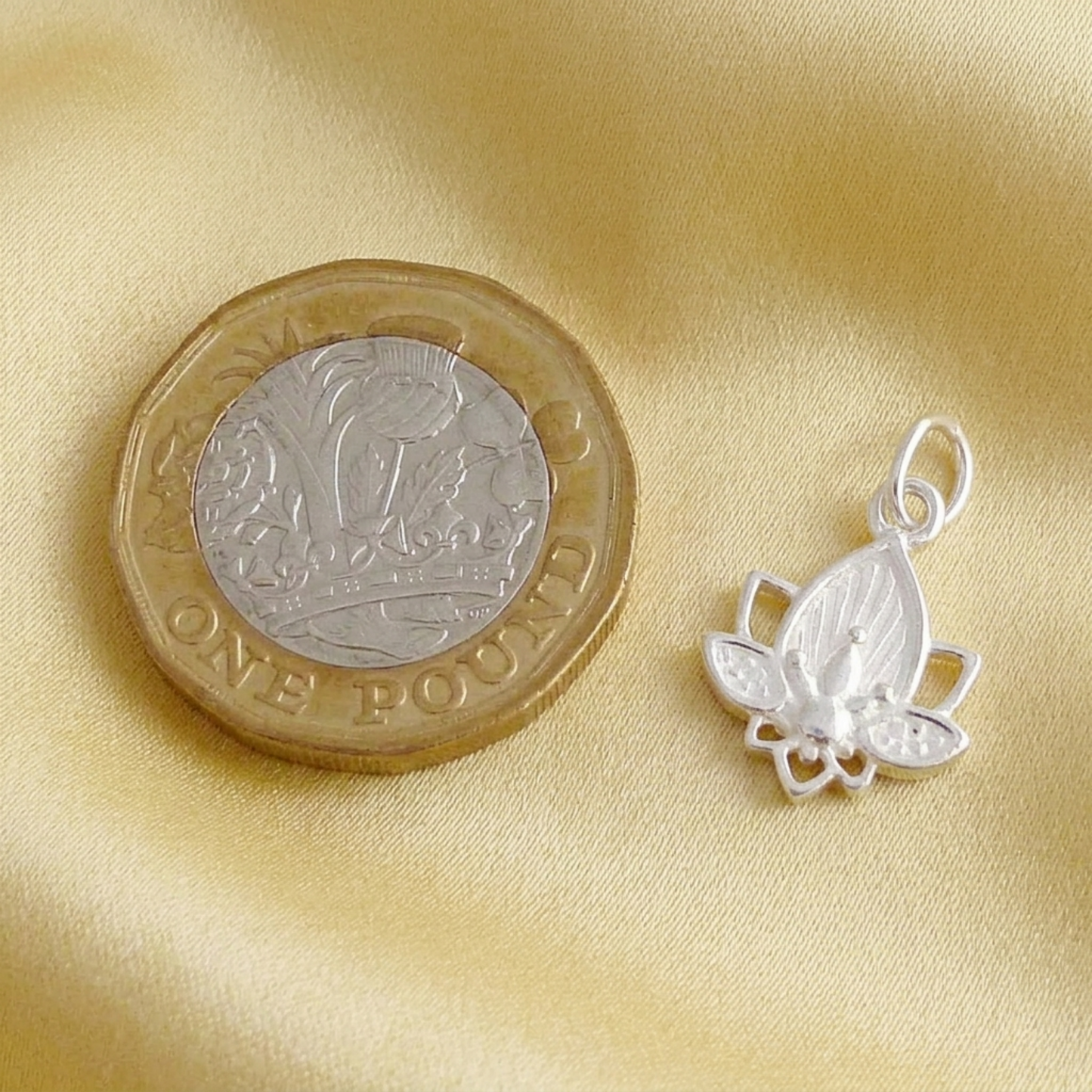 Lotus flower charm pendant close-up in silver tone with loop bail and lotus petals