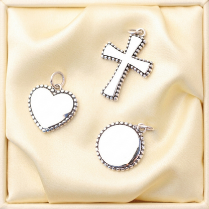 Heart charm pendant with beaded edge, top loop, and white enamel center