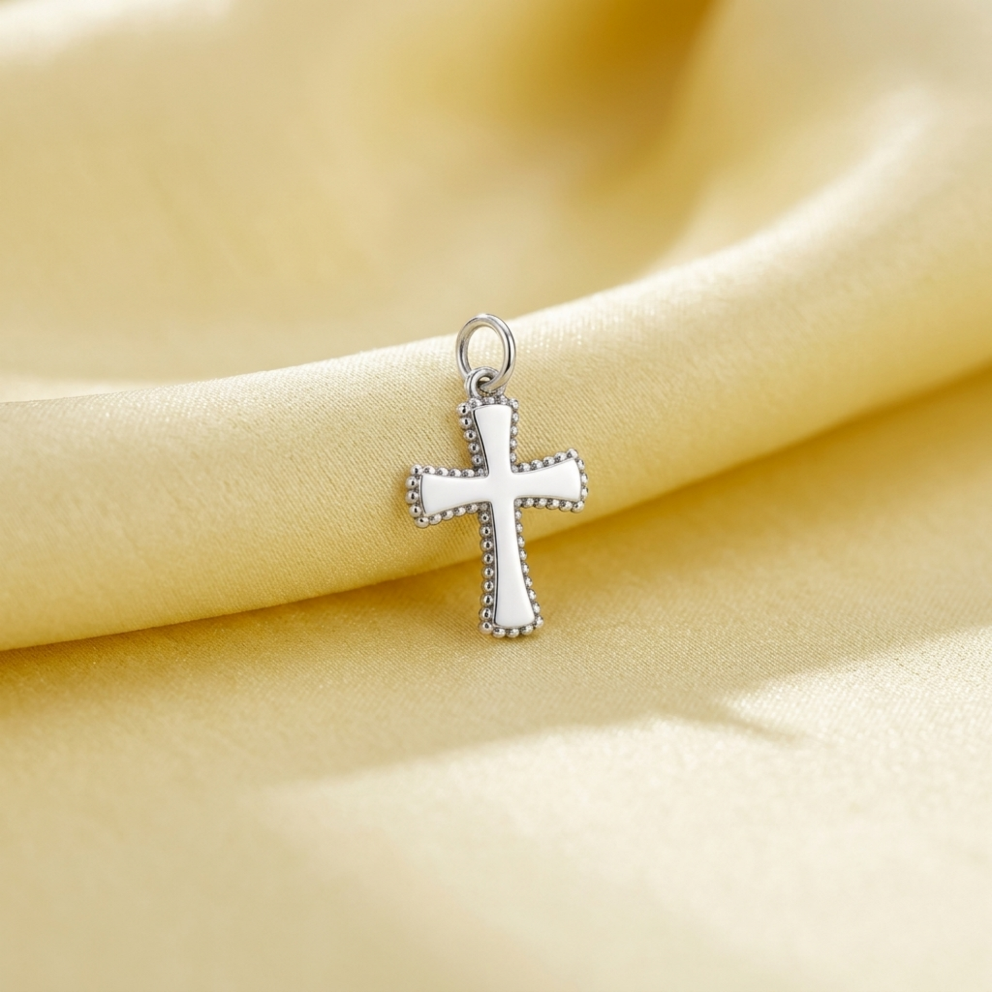 Beaded cross charm pendant with dark enamel details and silver-tone finish