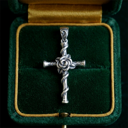 Silver cross pendant with twisting thorn rope design and rose center