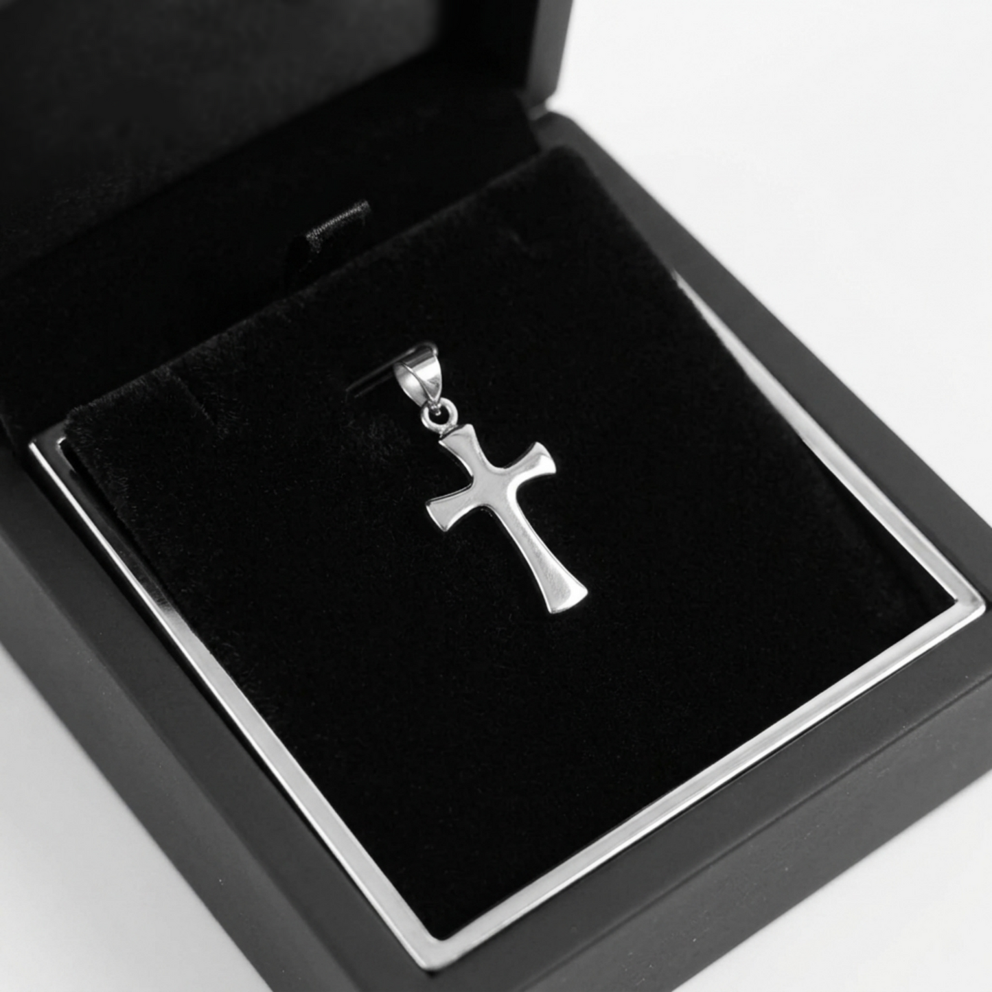 Polished cross pendant in a jewelry box with black velvet insert
