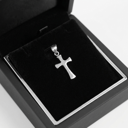 Polished cross pendant in a jewelry box with black velvet insert