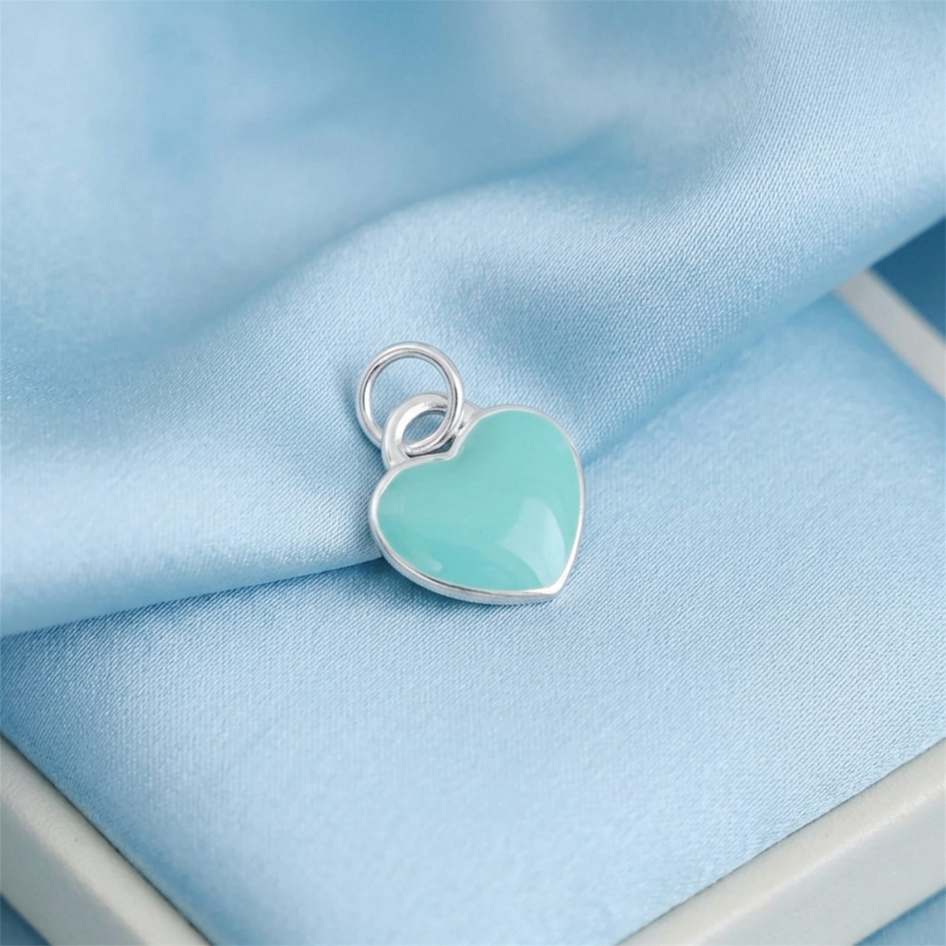 Turquoise heart charm pendant with silver bail and smooth glossy surface