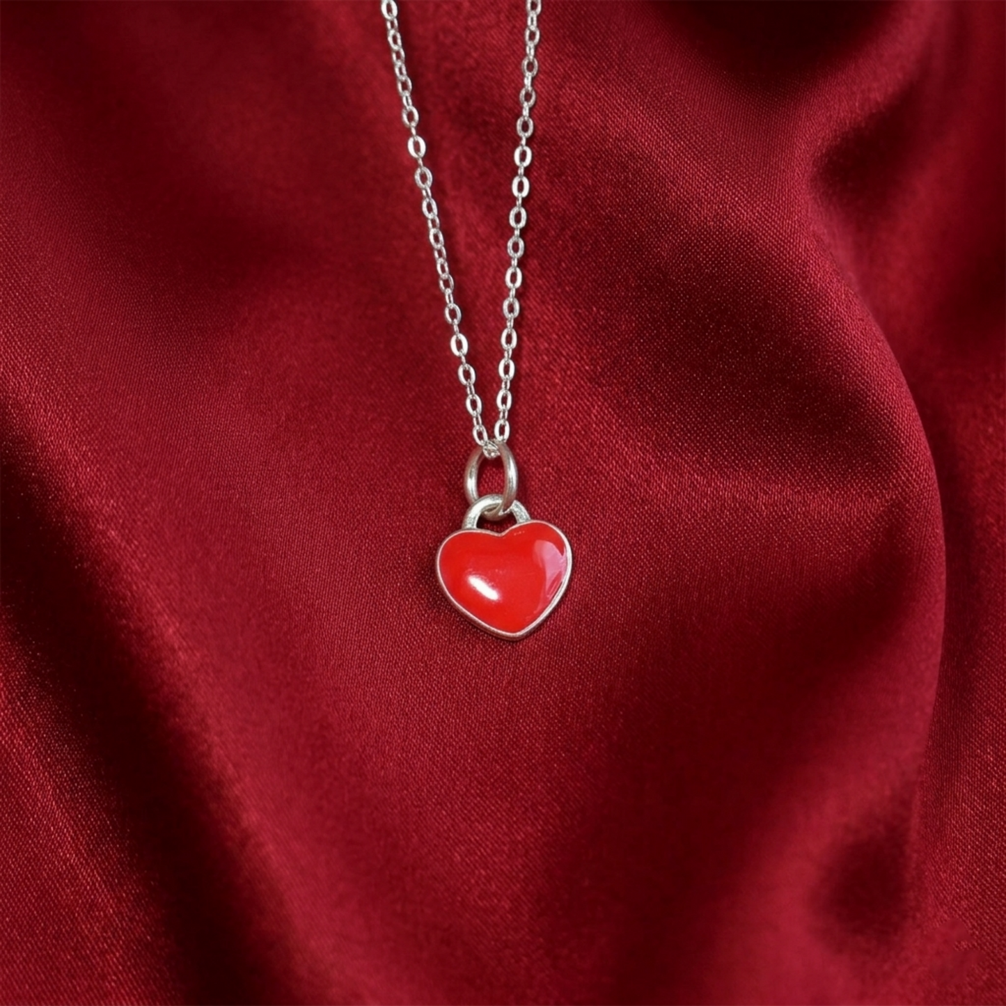 Silver chain necklace with red heart charm pendant