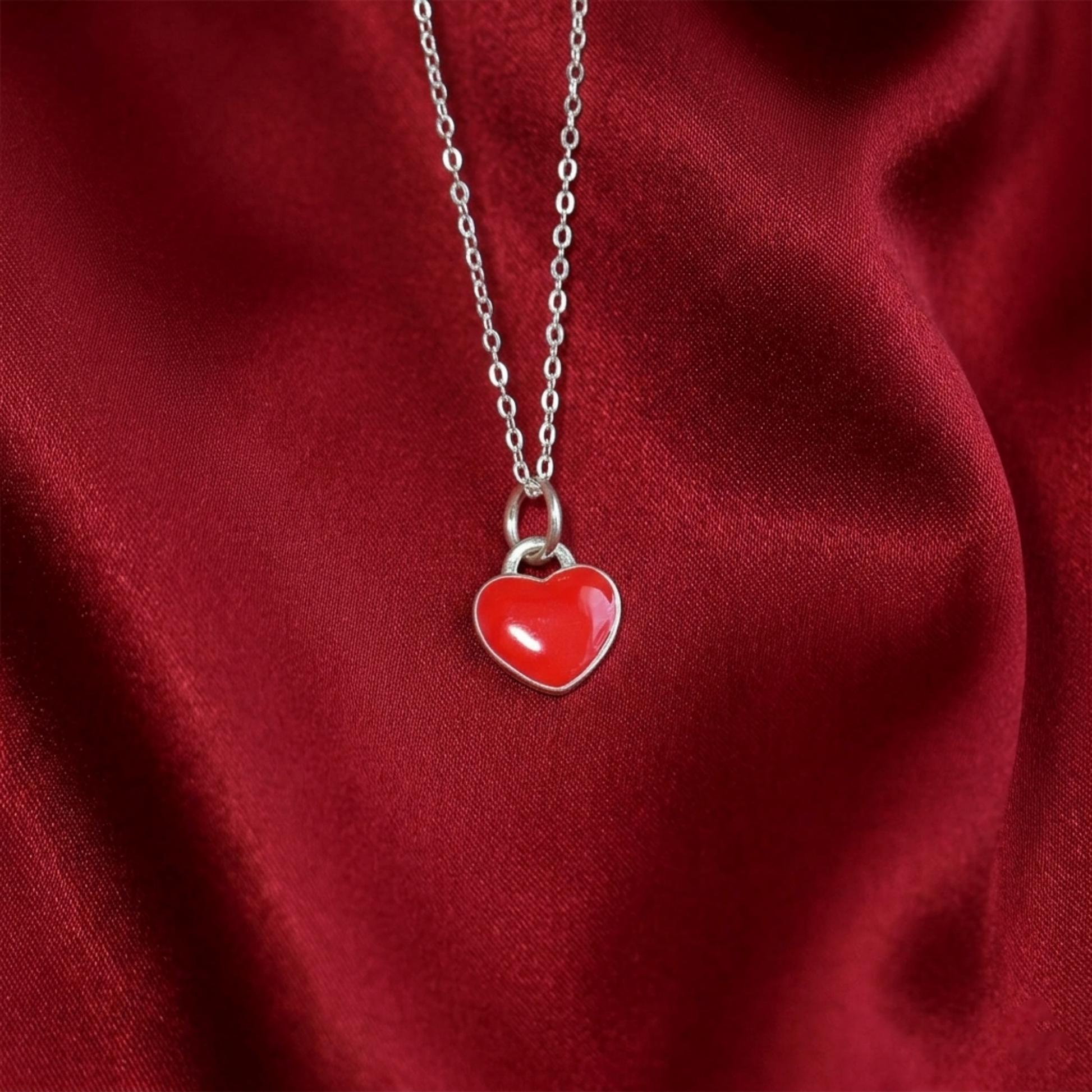 Silver chain necklace with red heart charm pendant