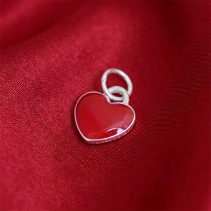 Red heart charm pendant with silver outline and small loop