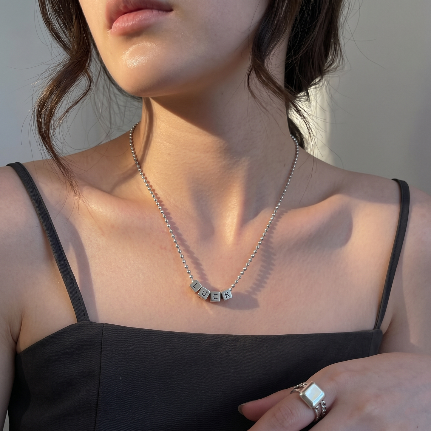 Silver cube-bead letter necklace with square cube charms on a fine chain