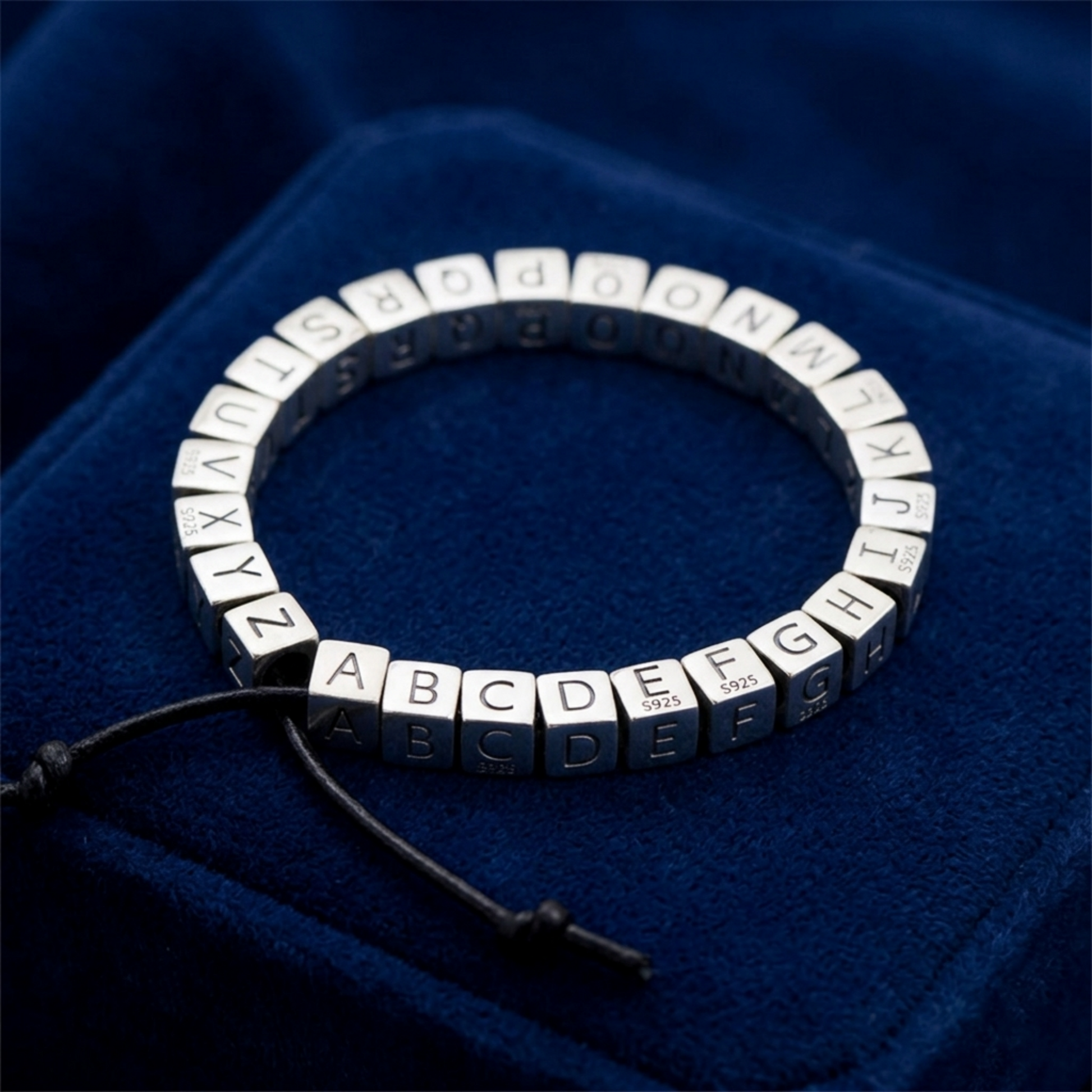 Alphabet cube charm bracelet with engraved letters A to Z on silver cubes