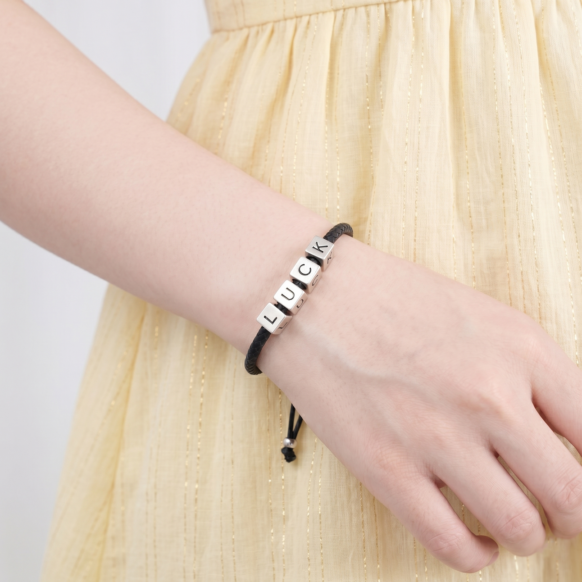 Black cord bracelet with silver cube beads engraved L U C K