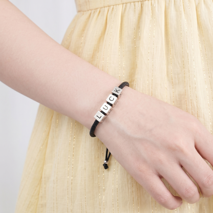 Black cord bracelet with silver cube beads engraved L U C K