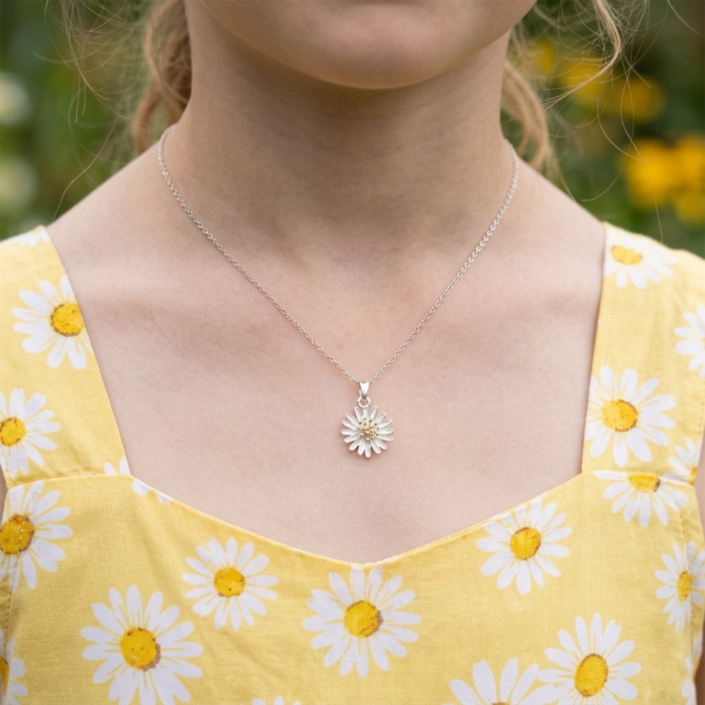 Daisy flower pendant necklace on model’s neck with silver chain and gold center