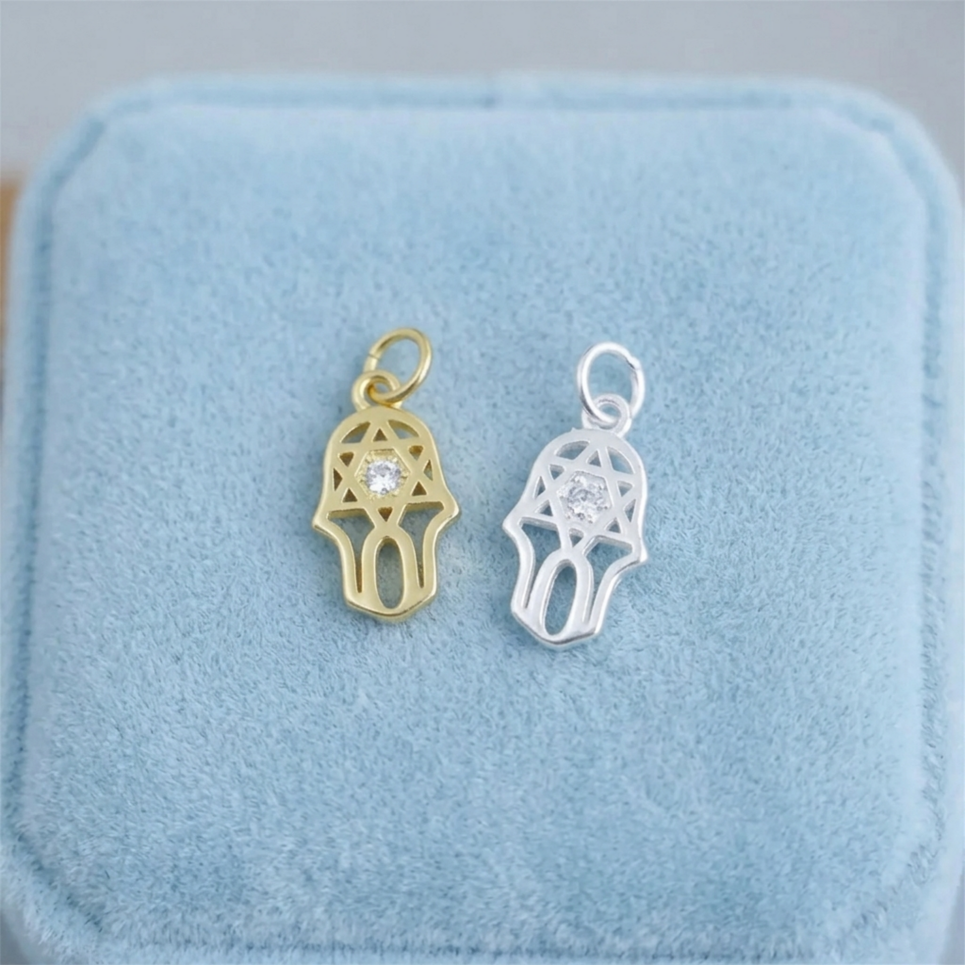 Gold and silver hamsa protection charm pendants with clear stones