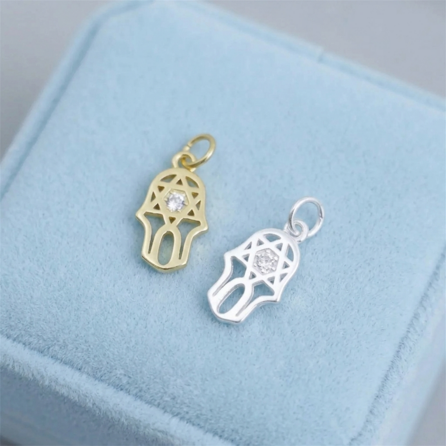 Gold and silver hamsa protection charm pendants with clear center stones