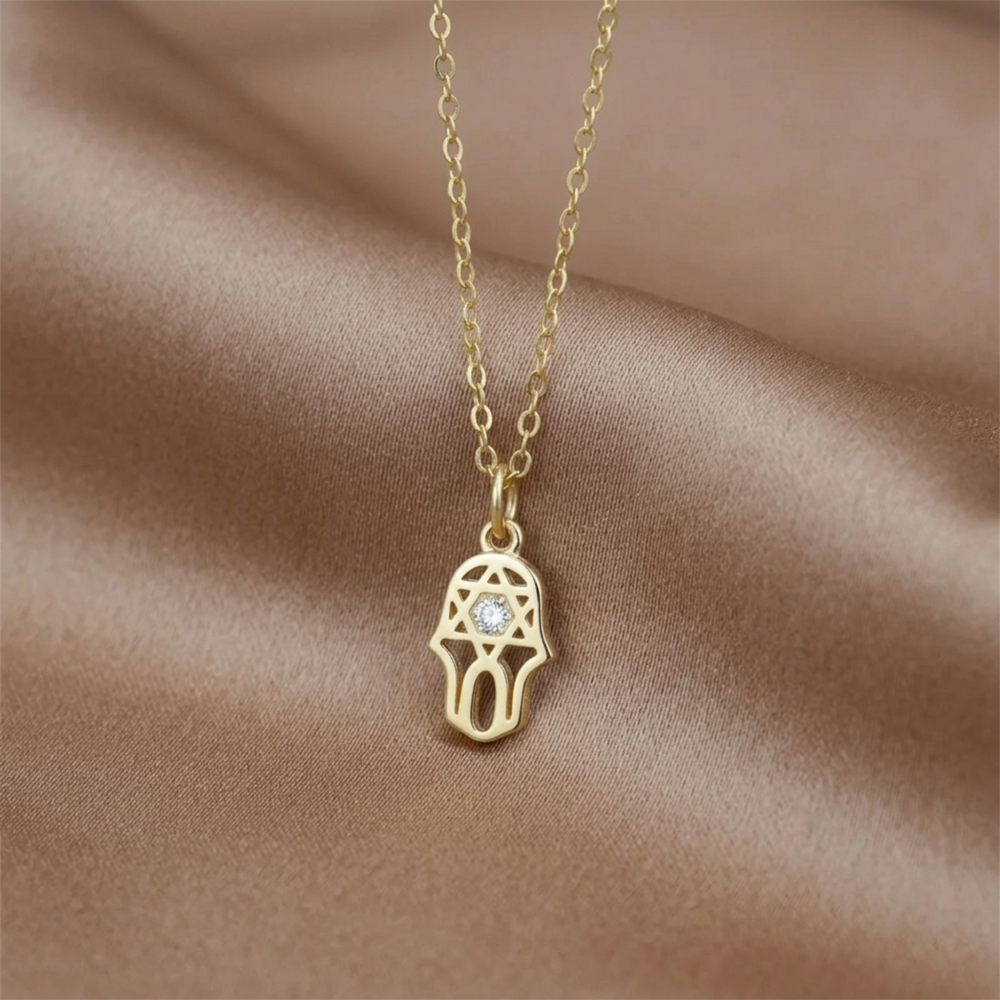 Gold necklace with hamsa protection charm pendant and clear stone
