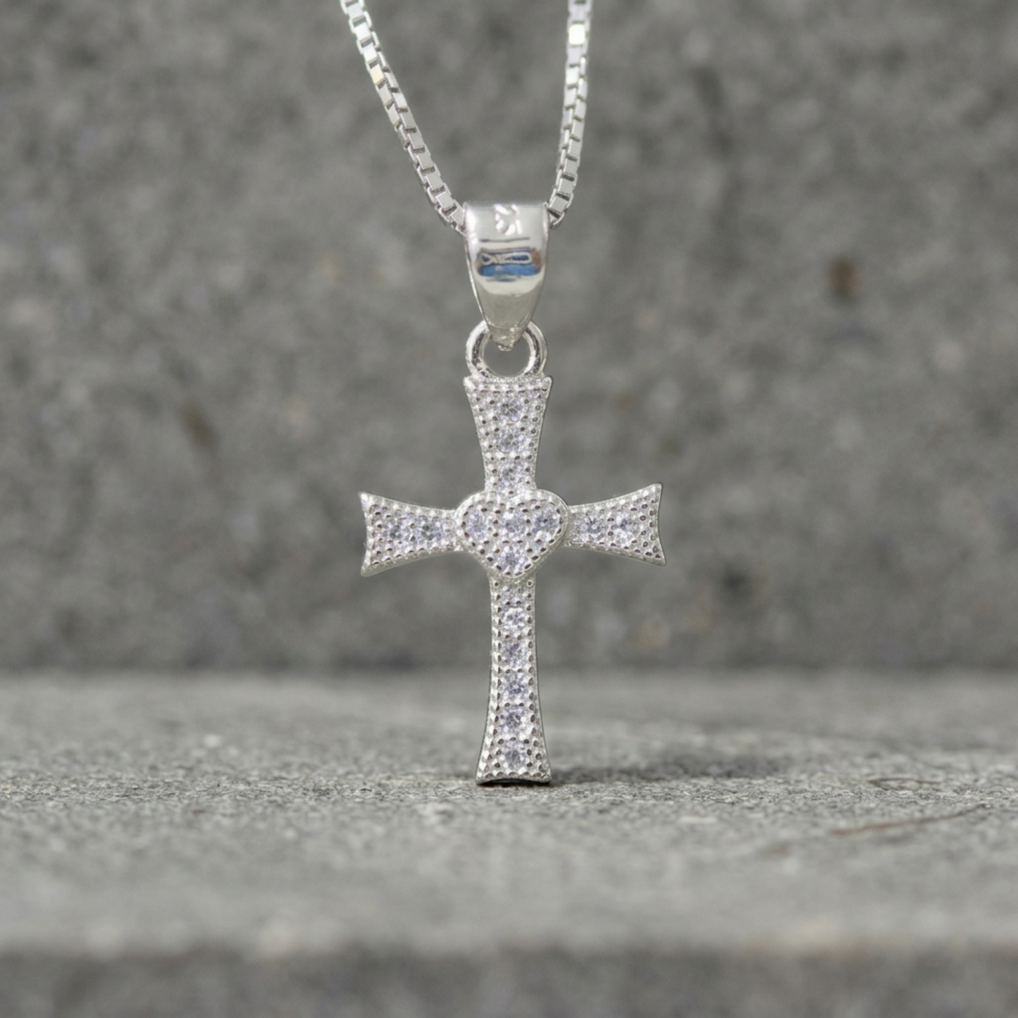 Silver heart cross pendant with CZ pavé, attached to silver chain