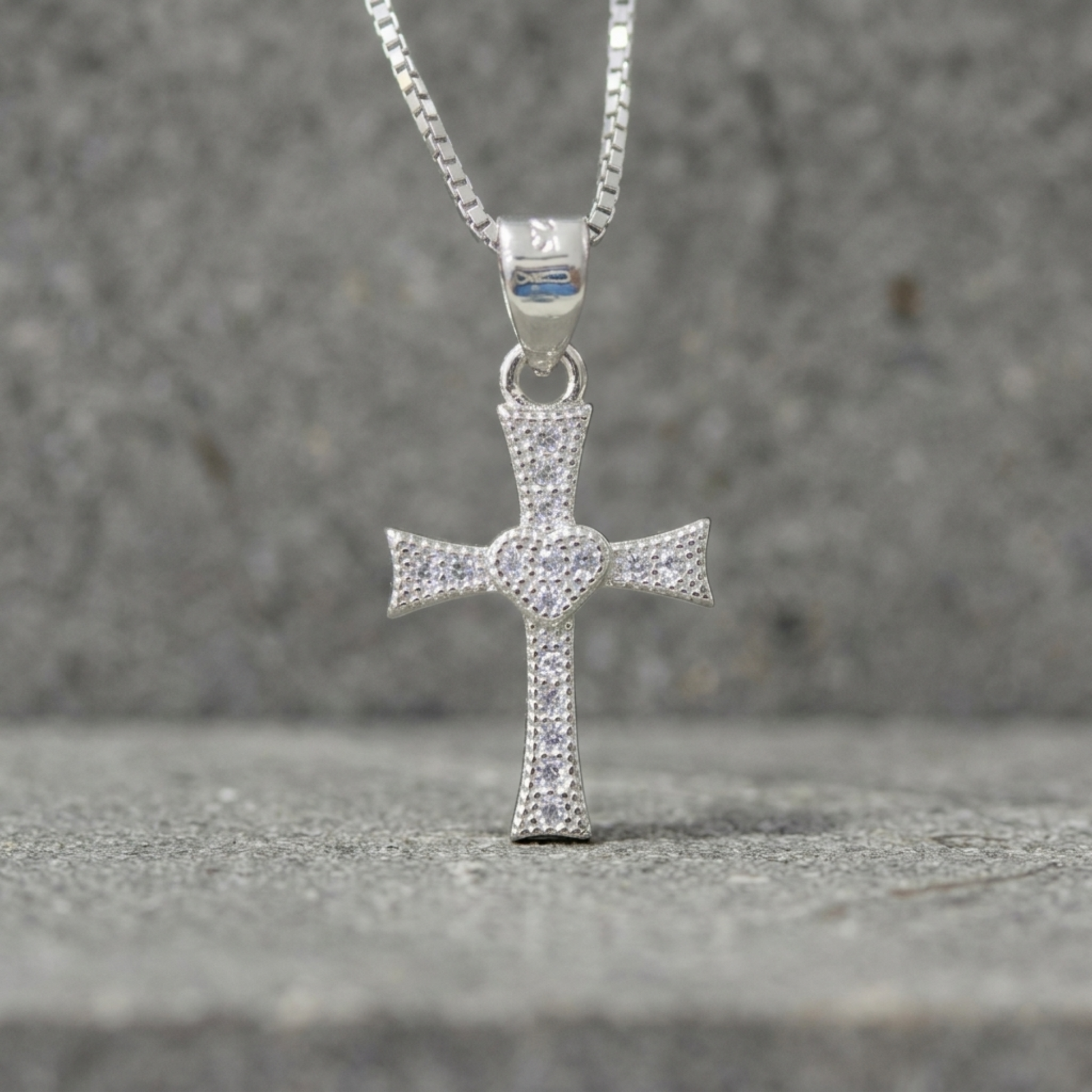 Silver heart cross pendant with CZ pavé, attached to silver chain