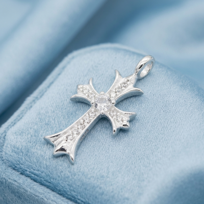 Silver cross pendant with pavé stones and round center, on blue velvet