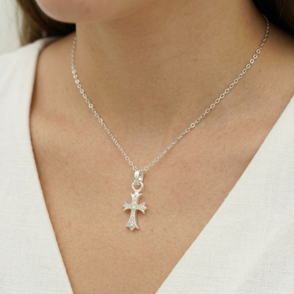 Silver cross pendant on a chain necklace with a round center and small pavé stones