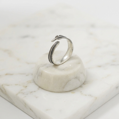 Silver feather wrap ring with two arched leaf-feather bands, side profile