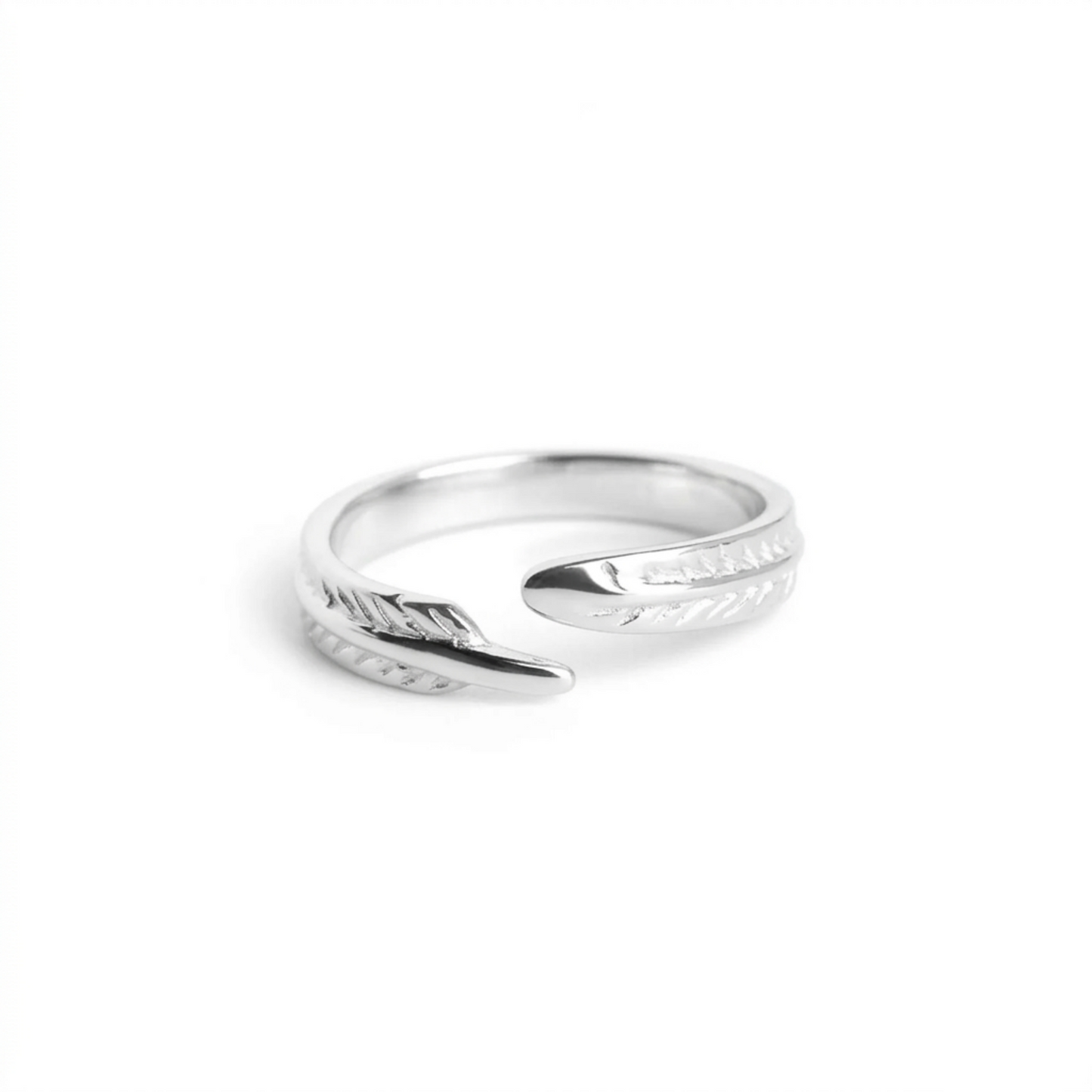 Silver open ring featuring angel feather wing engraving, angled view