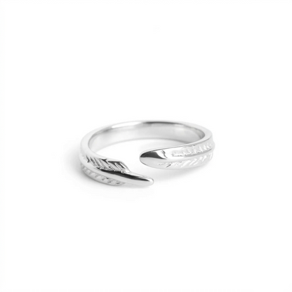 Silver open ring featuring angel feather wing engraving, angled view