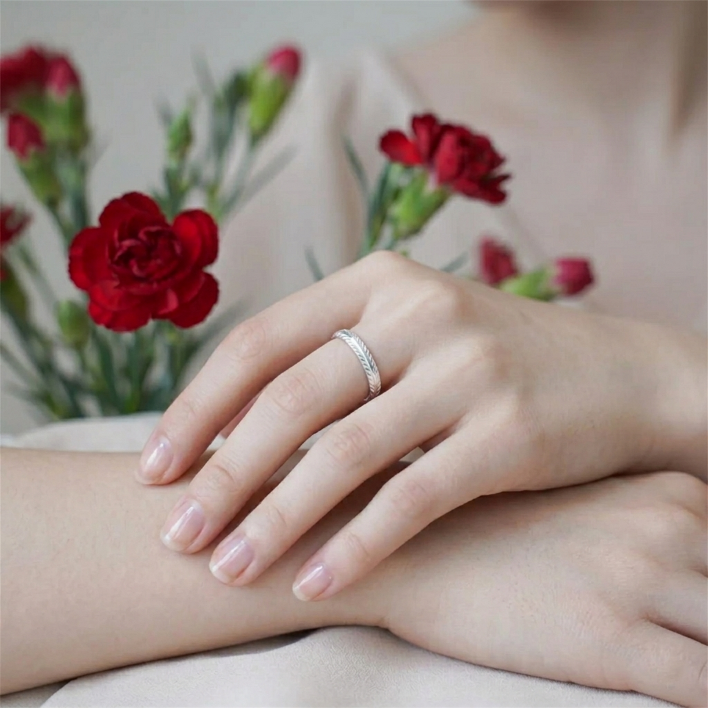 Silver feather wing open ring worn on a finger