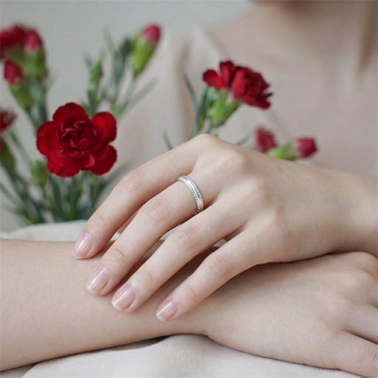 Silver feather wing open ring worn on a finger