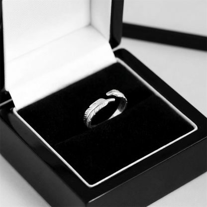 Silver feather wing open ring shown in a jewelry box