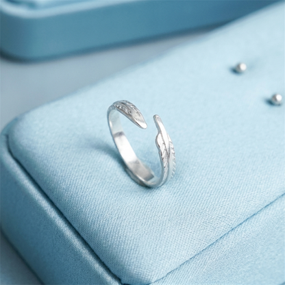 Silver feather wing open ring with leaf-like engraving on the side