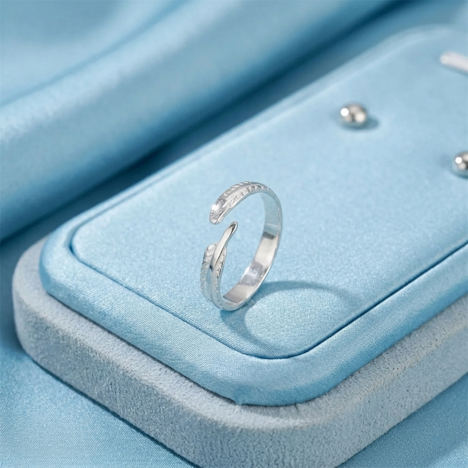 Silver feather wing open ring with textured band detail