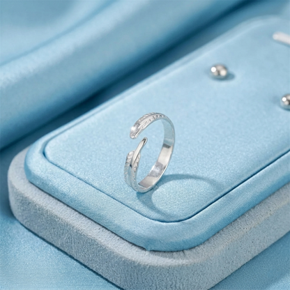 Silver feather wing open ring with textured band detail