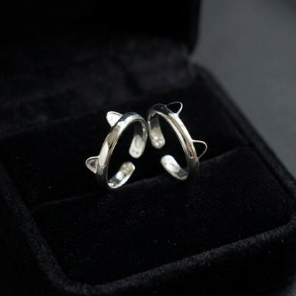 Silver-toned cat paw ring with black enamel tips shown in black jewelry box