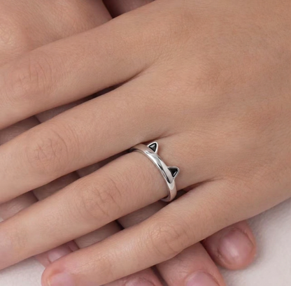 Silver-toned cat paw ring with black enamel tips on fingers, open band
