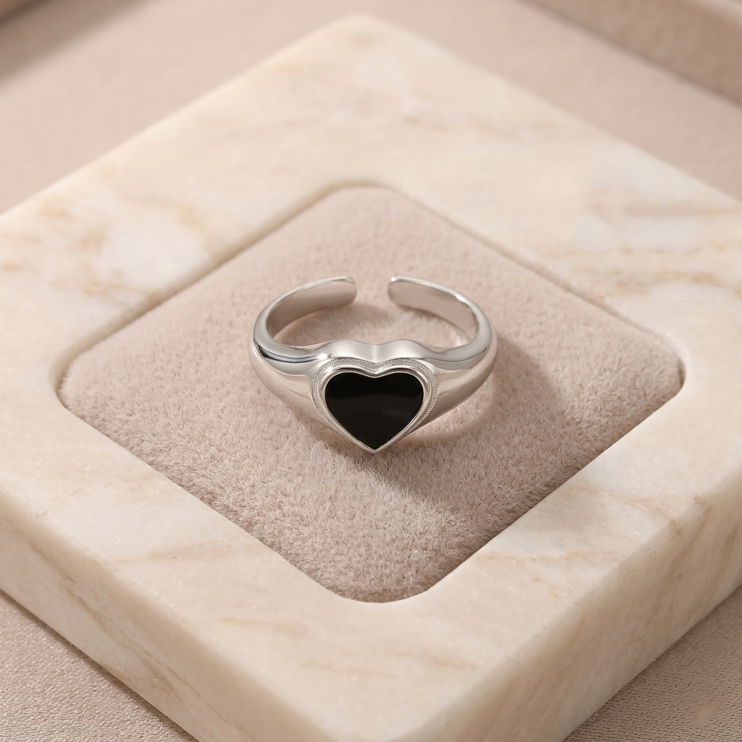 Silver heart ring with black heart bezel setting