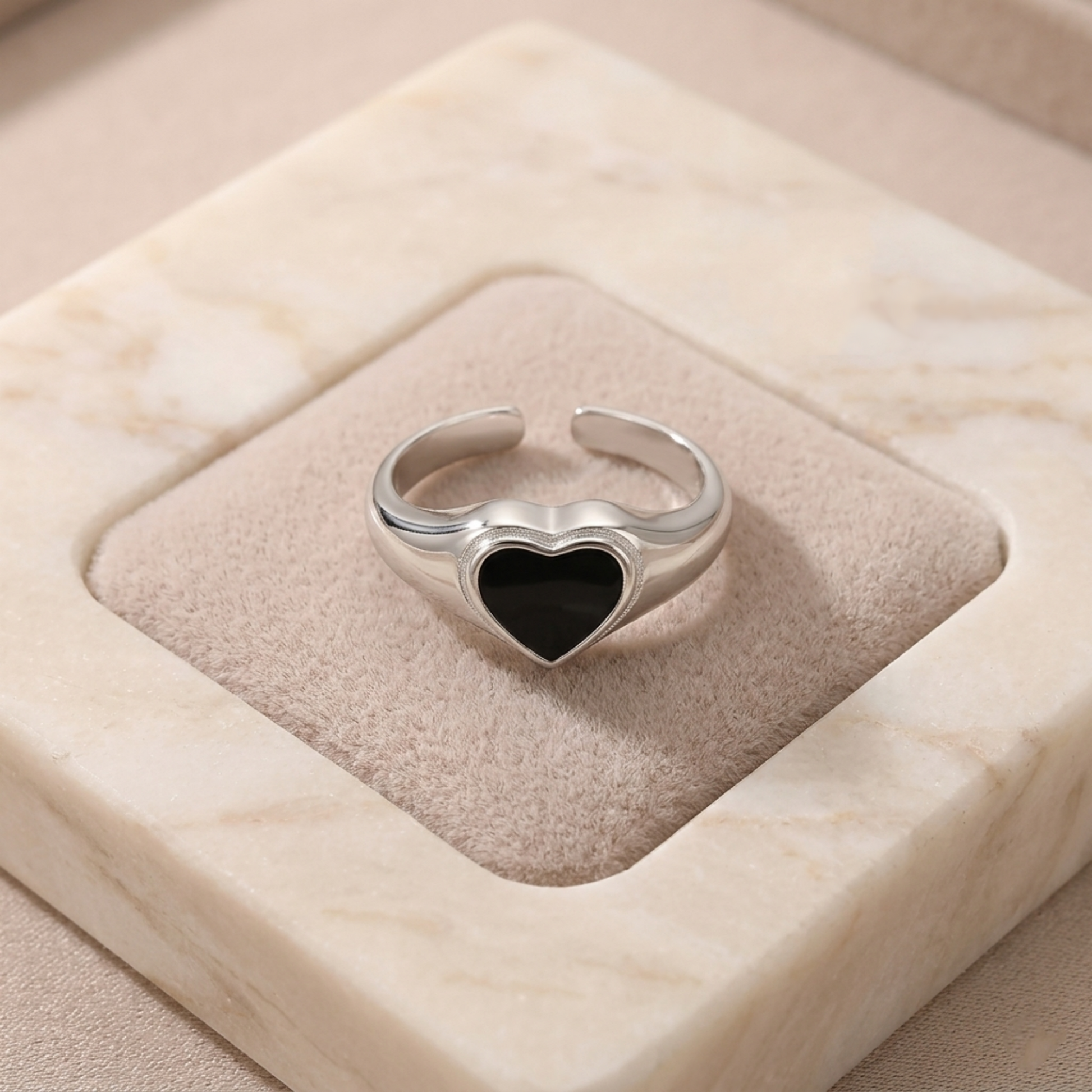 Silver heart ring with black heart bezel setting