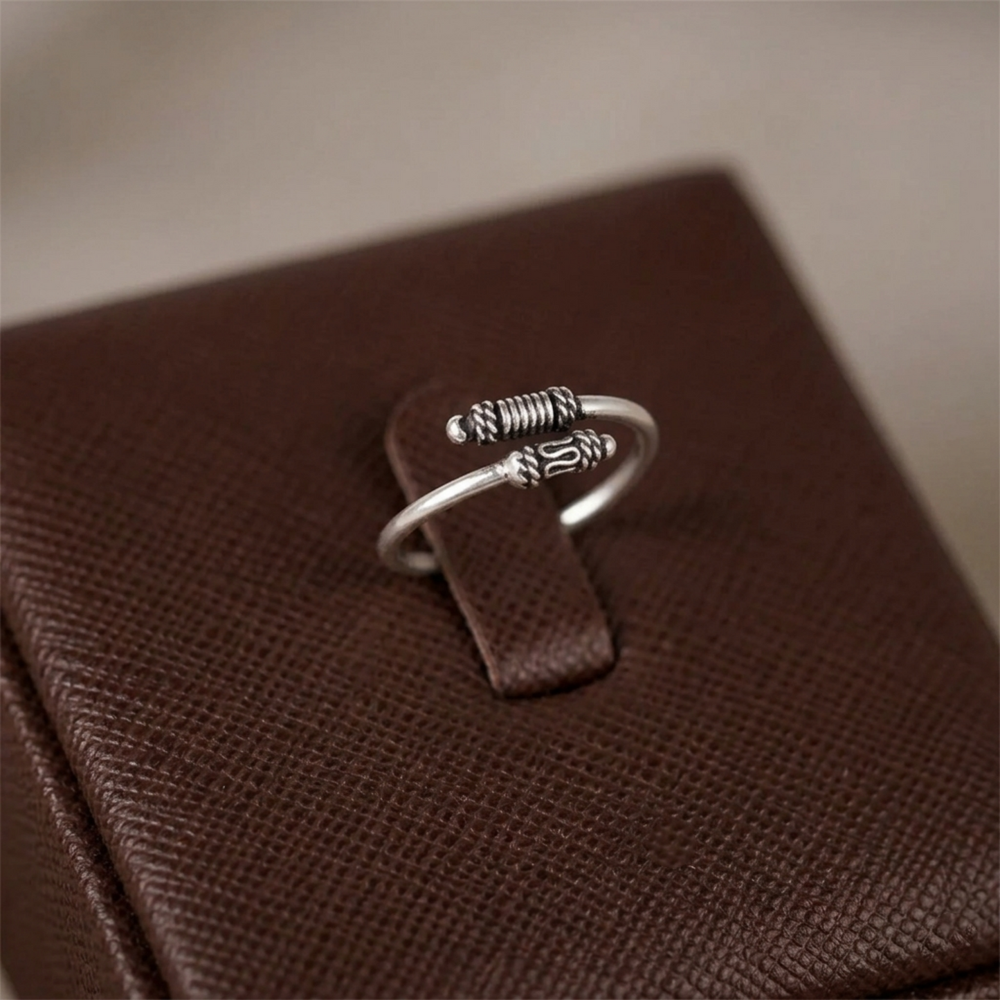 Oxidized silver totem knot ring, openwork ridged band with raised knot emblem