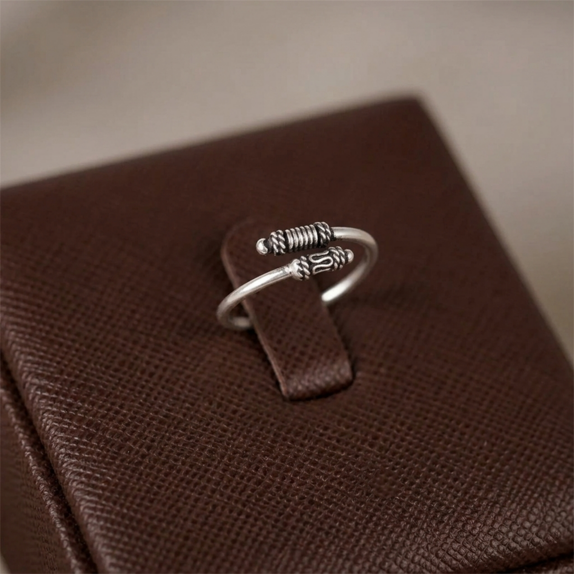 Oxidized silver totem knot ring, openwork ridged band with raised knot emblem