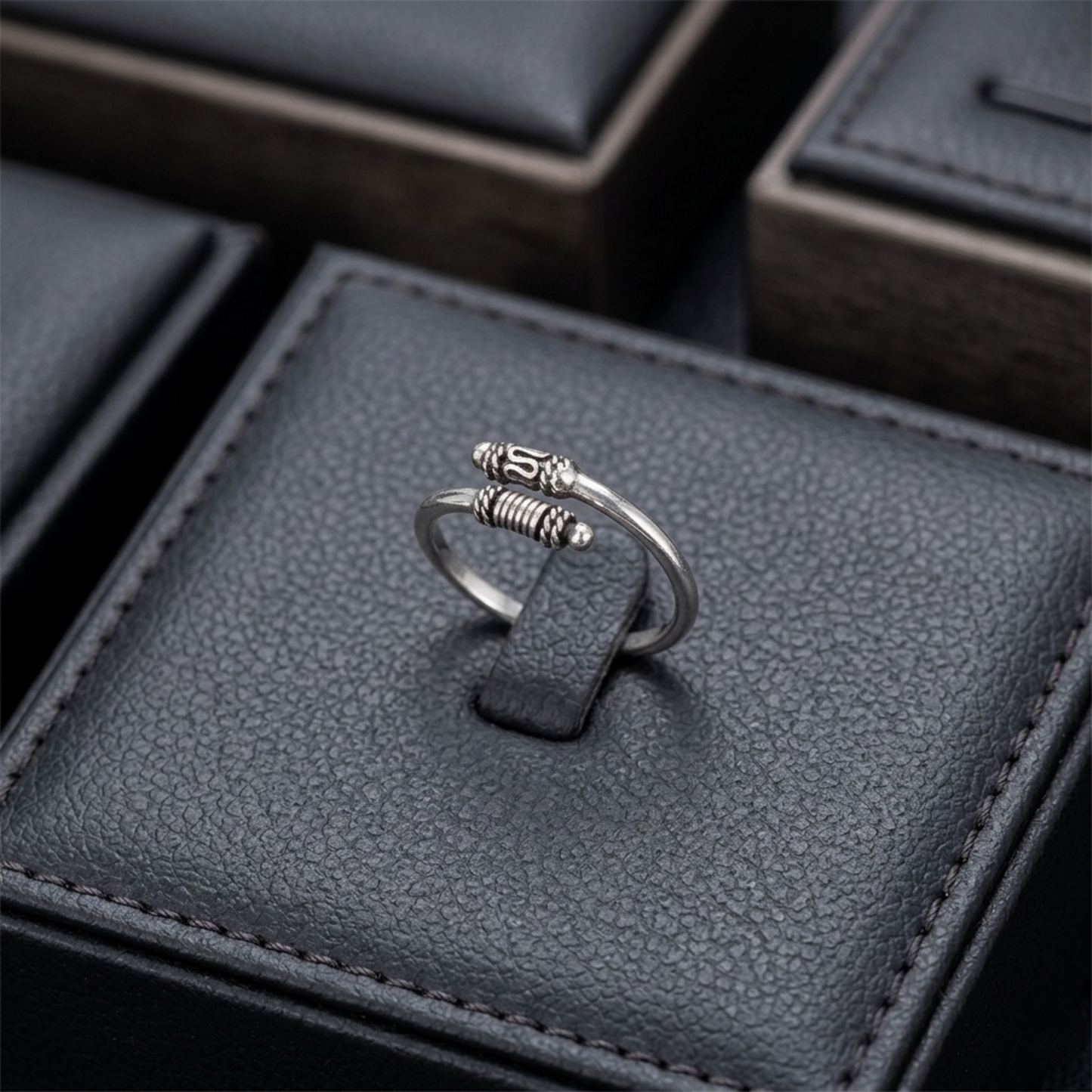 Oxidized silver totem knot ring featuring ridged band and detailed knot centerpiece