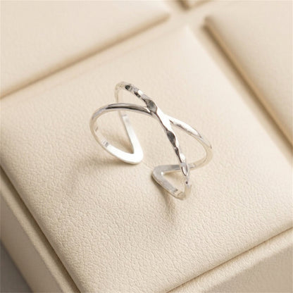 Silver criss-cross knot textured ring close-up on a display box