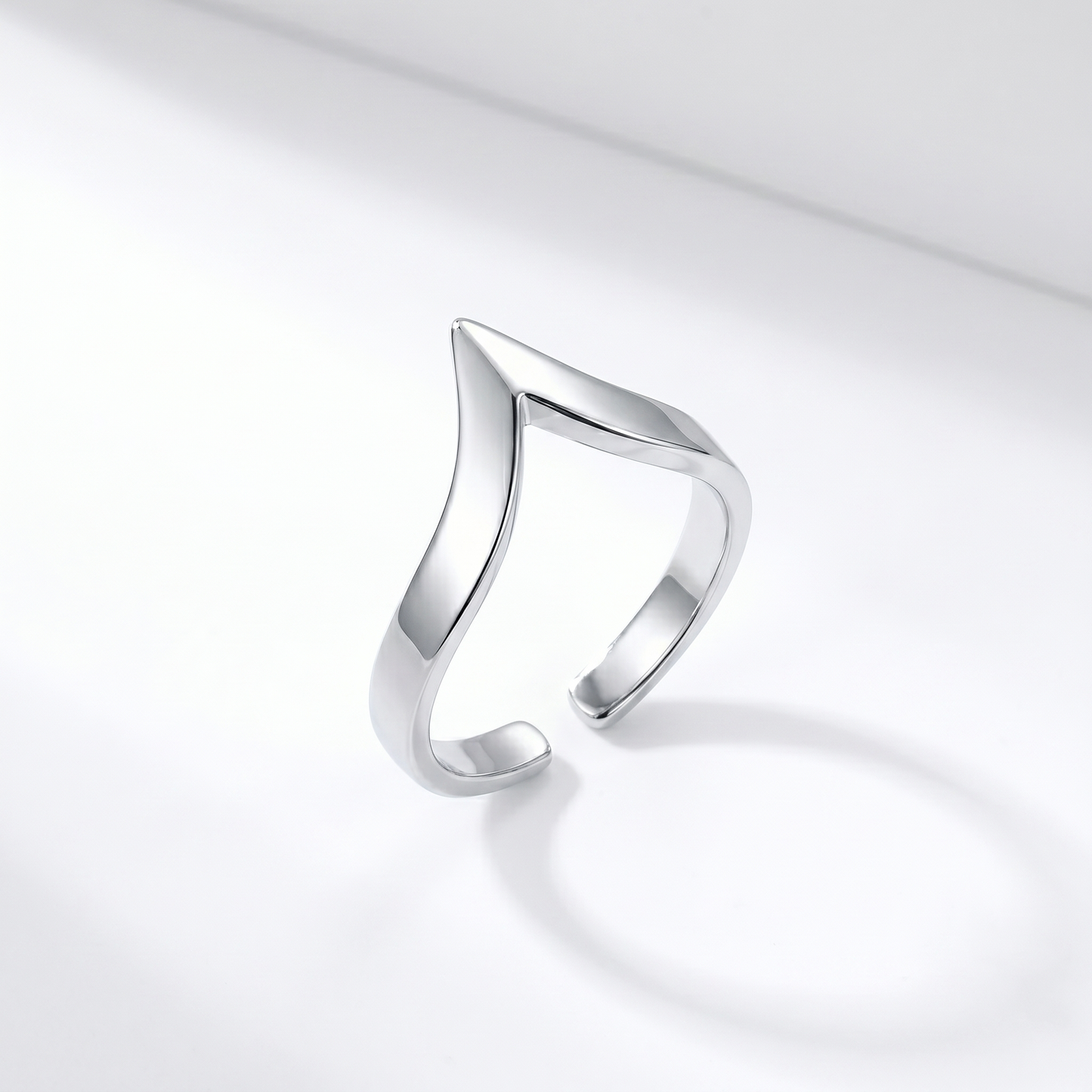 Silver wishbone V ring shown from the side, open V profile and shiny finish.